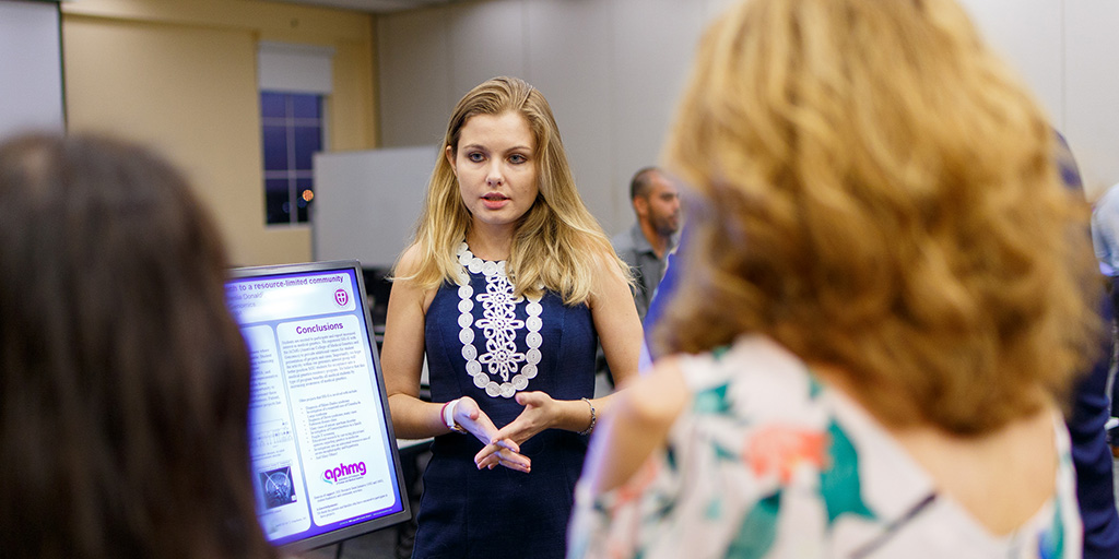 Student researchers present their work to visiting alumni during the School of Medicine Alumni Association's continuing medical education conference