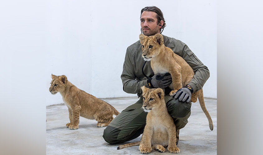 Andrew Kushnir, DVM '19, with rescued lion cubs from Ukraine-Russia war