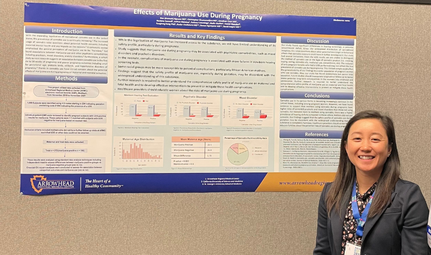 Hannah Nguyen standing with her research poster