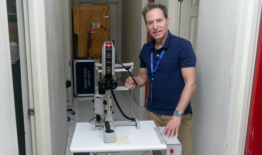 Dr. Spier poses with ophthalmology equipment