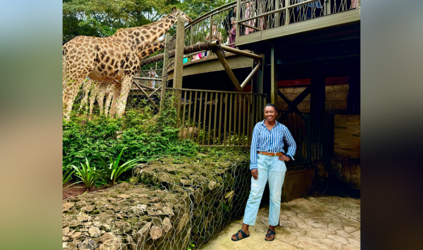 Tiara Singletary with a giraffe in Kenya