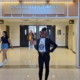 Alanda Joseph standing in front of "University at Albany sign"