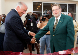 Charles Modica and Patrick Adams cut a ribbon at the dedication of the new Patrick F. Adams Hall in 2011.