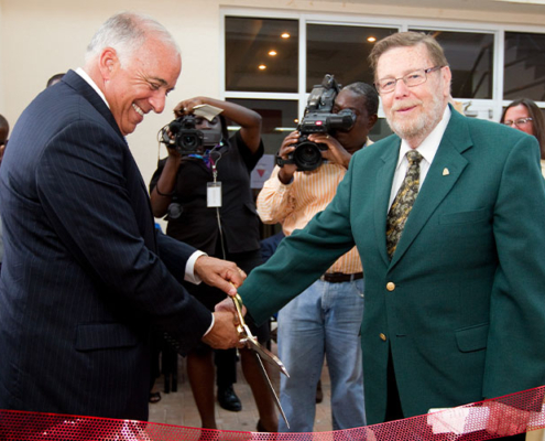 Charles Modica and Patrick Adams cut a ribbon at the dedication of the new Patrick F. Adams Hall in 2011.