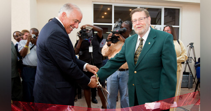 Charles Modica and Patrick Adams cut a ribbon at the dedication of the new Patrick F. Adams Hall in 2011. 